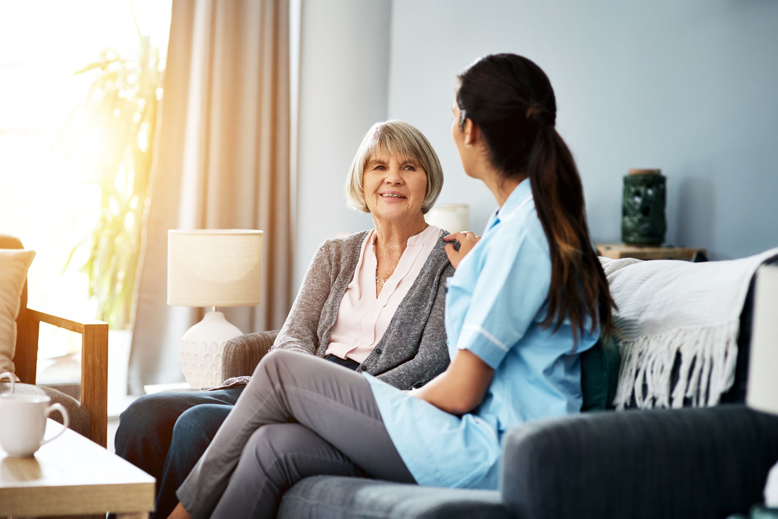 old woman and nurse talking